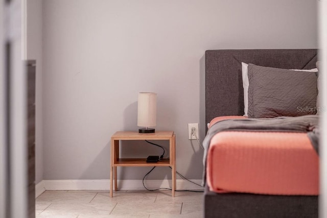 bedroom featuring baseboards and tile patterned flooring