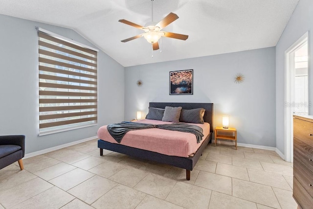 bedroom with baseboards, a ceiling fan, light tile patterned floors, and vaulted ceiling