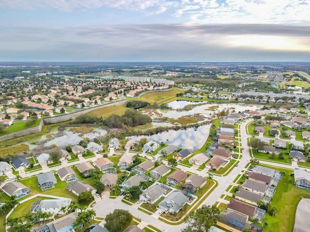 birds eye view of property with a water view and a residential view