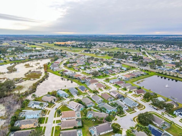 drone / aerial view featuring a water view and a residential view