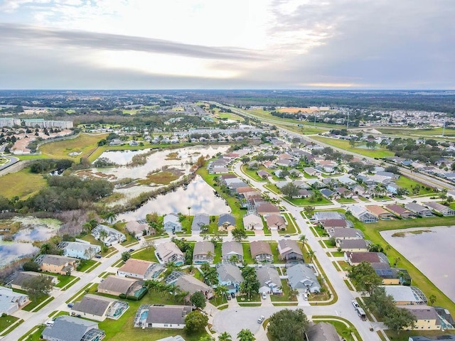 birds eye view of property with a residential view and a water view