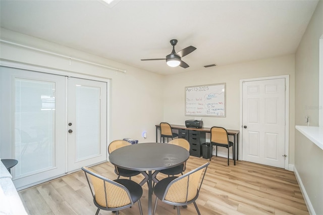 dining room featuring visible vents, light wood-style floors, ceiling fan, and french doors