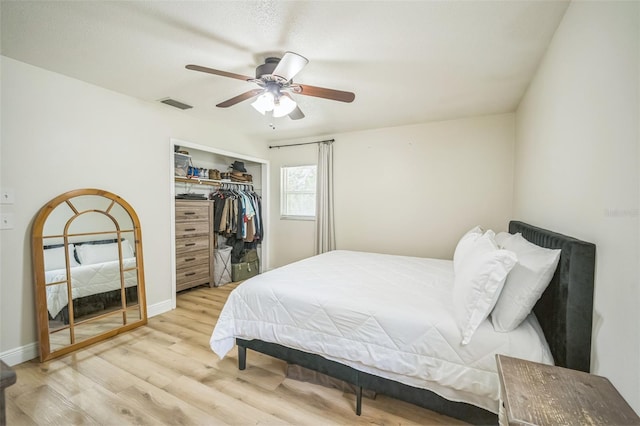 bedroom with a ceiling fan, visible vents, baseboards, a closet, and light wood finished floors