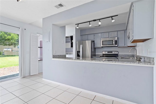 611 Casa Park A Ct, Winter Springs, FL 32708 - kitchen with a sink, track lighting, visible vents, appliances with stainless steel finishes, and light stone counters