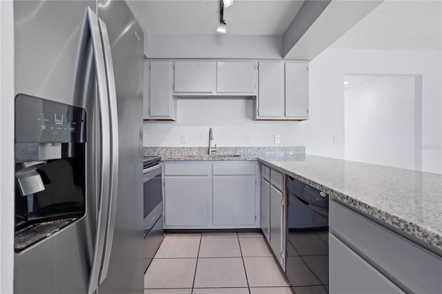 611 Casa Park A Ct, Winter Springs, FL 32708 - kitchen with a sink, white cabinets, appliances with stainless steel finishes, light stone counters, and light tile patterned flooring