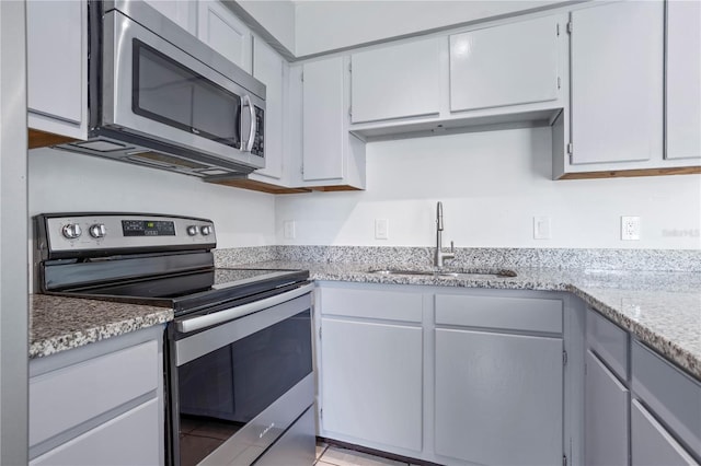 611 Casa Park A Ct, Winter Springs, FL 32708 - kitchen featuring a sink, light stone countertops, and appliances with stainless steel finishes