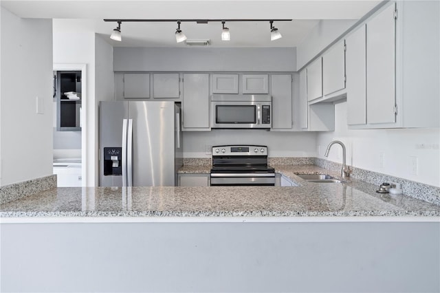 611 Casa Park A Ct, Winter Springs, FL 32708 - kitchen featuring a sink, a peninsula, stainless steel appliances, and rail lighting