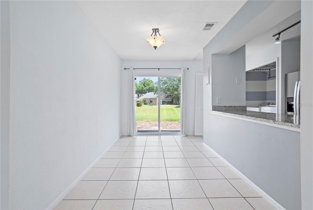 611 Casa Park A Ct, Winter Springs, FL 32708 - empty room with visible vents, baseboards, and light tile patterned flooring