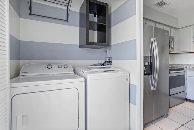 611 Casa Park A Ct, Winter Springs, FL 32708 - laundry room featuring washer and clothes dryer, visible vents, and light tile patterned floors