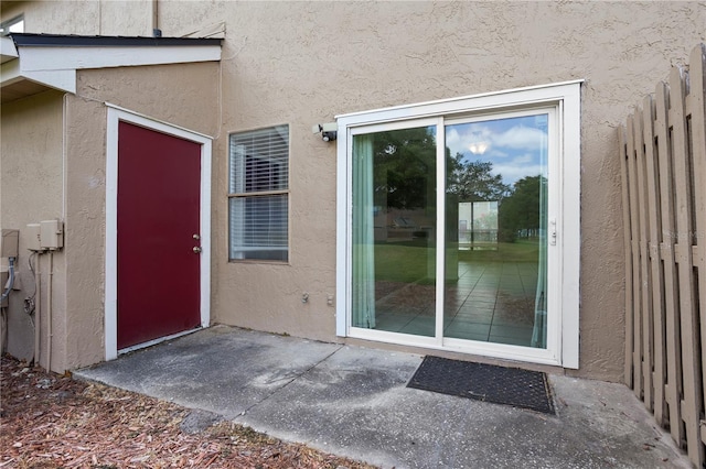 611 Casa Park A Ct, Winter Springs, FL 32708 - view of exterior entry featuring a patio area, stucco siding, and fence