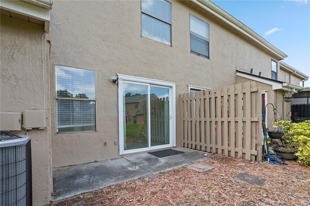 611 Casa Park A Ct, Winter Springs, FL 32708 - back of house with cooling unit, stucco siding, and fence