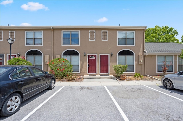 611 Casa Park A Ct, Winter Springs, FL 32708 - view of property with stucco siding and uncovered parking