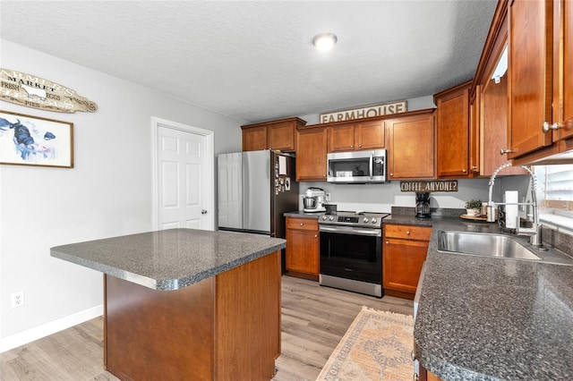 1555 Seminole Run Rd, Osteen, FL 32764 - kitchen with a sink, light wood-style flooring, appliances with stainless steel finishes, and dark countertops