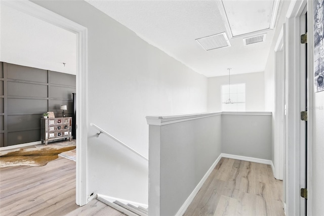 1555 Seminole Run Rd, Osteen, FL 32764 - hallway featuring baseboards, visible vents, wood finished floors, and an upstairs landing
