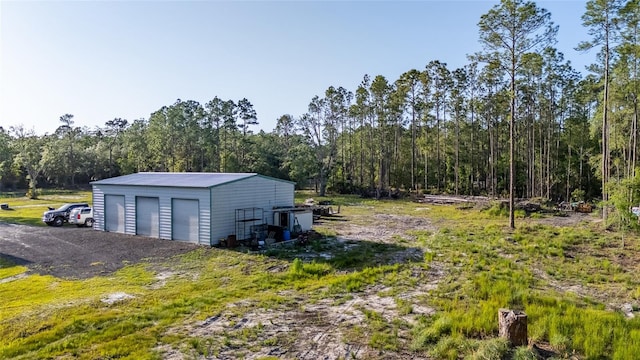 1555 Seminole Run Rd, Osteen, FL 32764 - detached garage featuring a view of trees