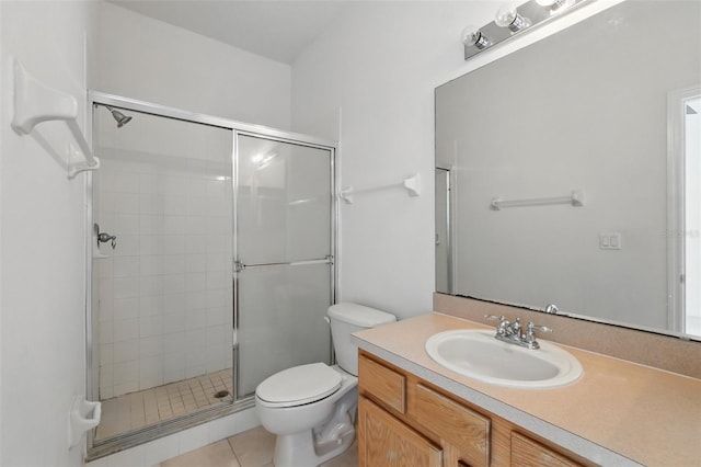 bathroom with vanity, tile patterned flooring, a shower stall, and toilet