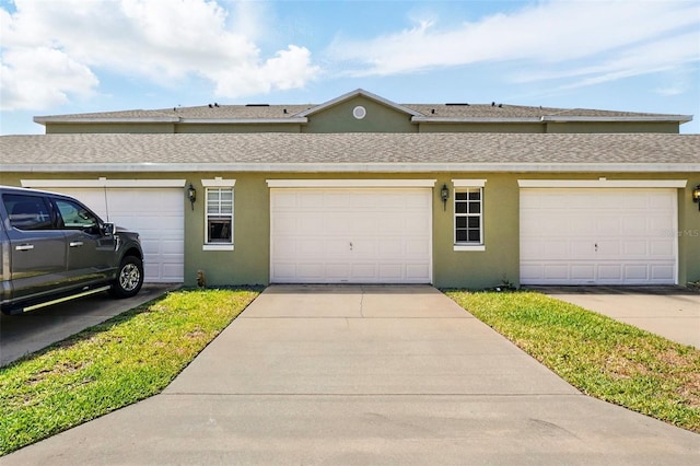 view of front of house featuring a shingled roof and stucco siding