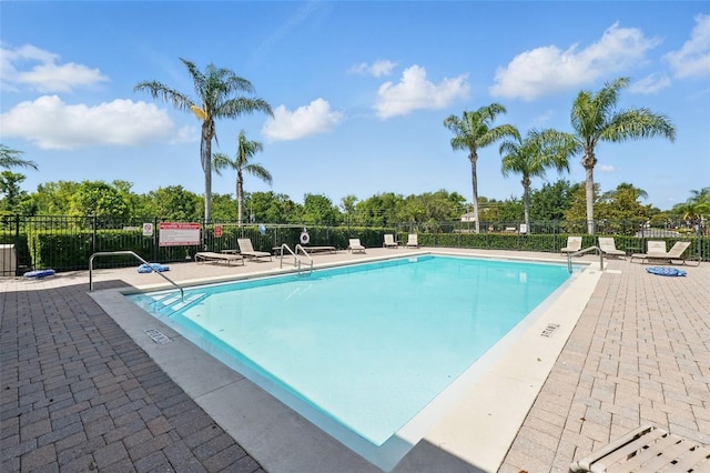 community pool featuring a patio area and fence