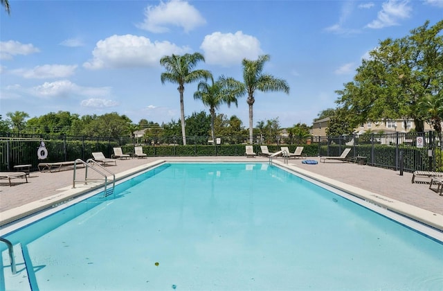 pool with fence and a patio