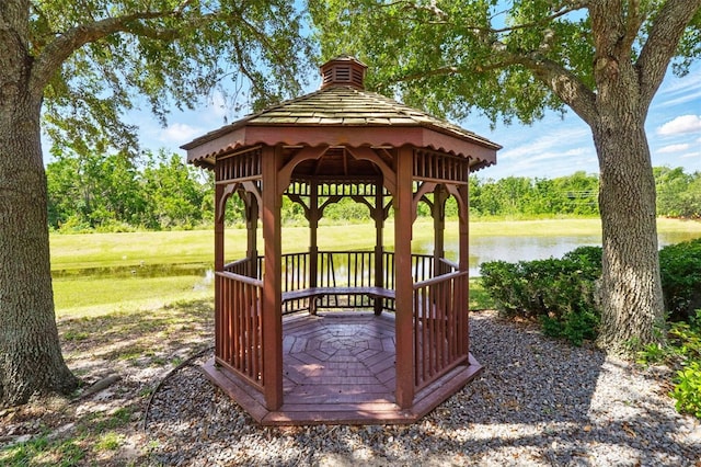view of community with a water view, a gazebo, and a yard