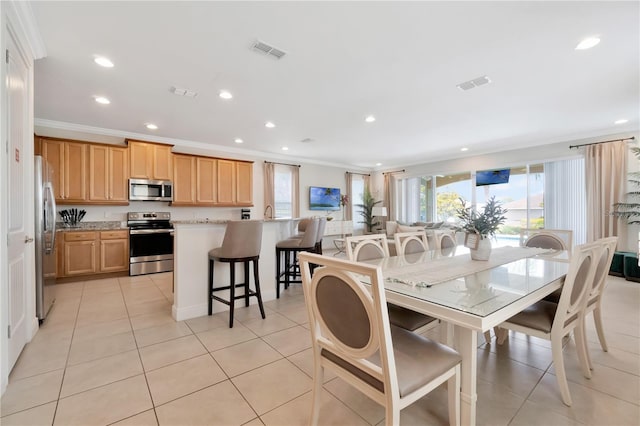 dining area featuring crown molding, recessed lighting, light tile patterned flooring, and visible vents