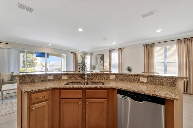 kitchen featuring stainless steel dishwasher, open floor plan, a sink, and visible vents