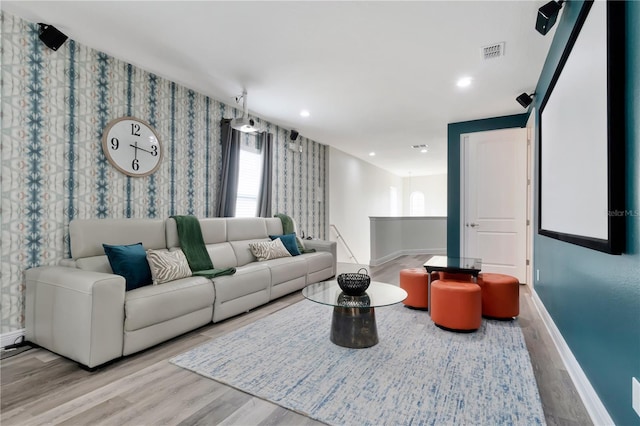 living area featuring baseboards, wood finished floors, and visible vents