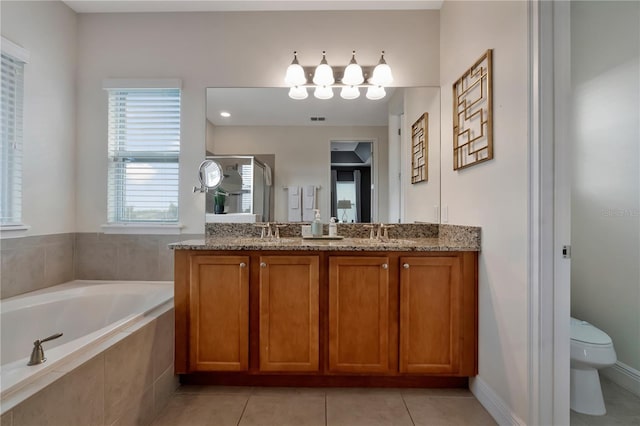 full bathroom with a garden tub, a sink, a stall shower, and toilet