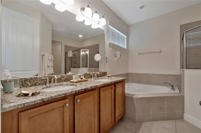 full bathroom featuring double vanity, a garden tub, a stall shower, a sink, and tile patterned floors