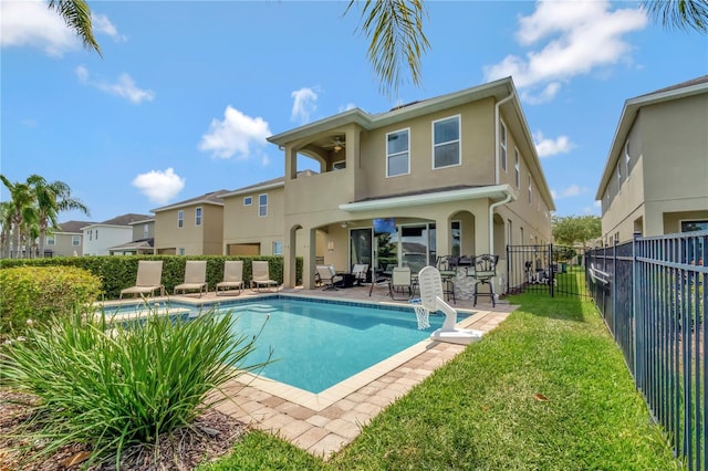 back of house featuring a fenced in pool, fence, a balcony, a patio, and stucco siding