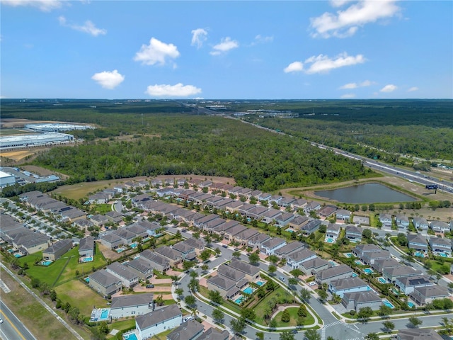 bird's eye view featuring a water view, a view of trees, and a residential view