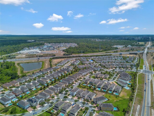 drone / aerial view with a water view and a residential view
