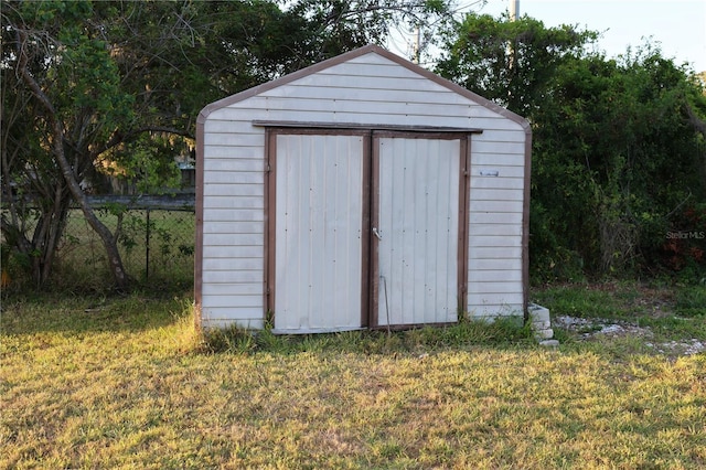 view of shed with fence