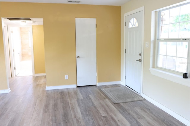 entryway featuring baseboards, visible vents, and light wood-style floors