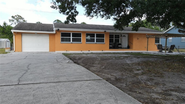 single story home with an attached garage, stucco siding, and driveway