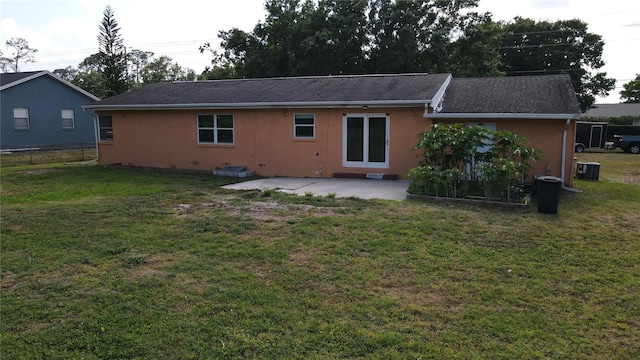 back of property featuring a yard, a patio, fence, and stucco siding