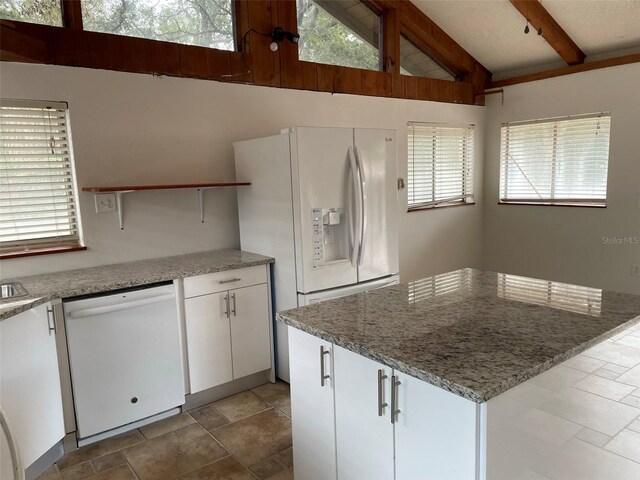 530 Webster St, Lake Mary, FL 32746 - kitchen with white appliances, a kitchen island, white cabinetry, and plenty of natural light