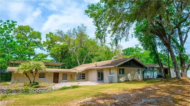 530 Webster St, Lake Mary, FL 32746 - rear view of house featuring stucco siding and a lawn