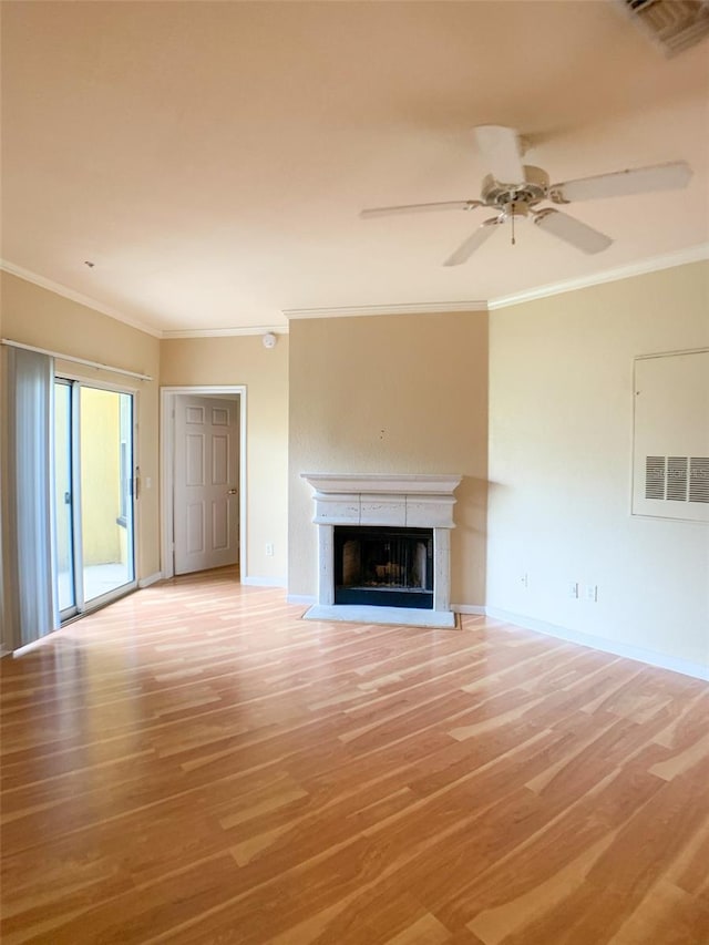 unfurnished living room featuring visible vents, ornamental molding, light wood finished floors, and a fireplace