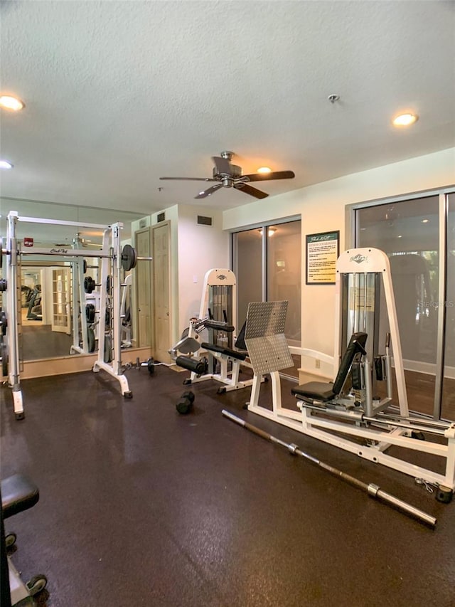 exercise room with a ceiling fan, a textured ceiling, recessed lighting, and baseboards