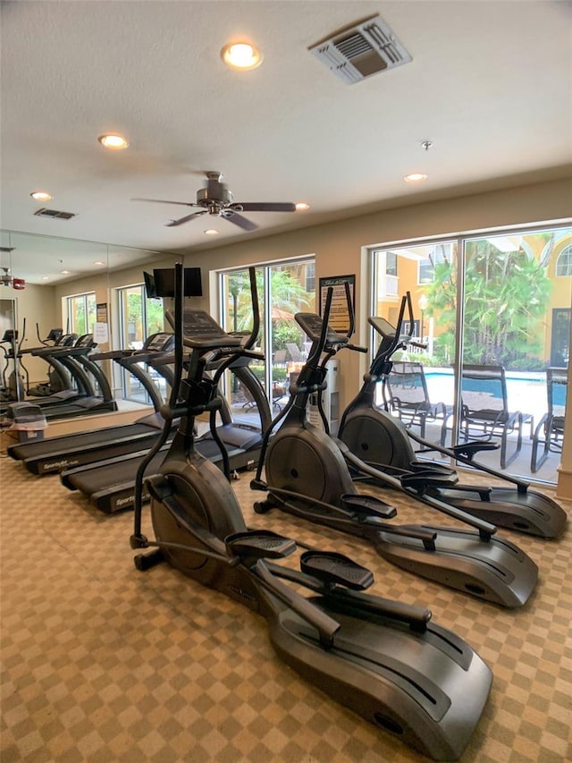 gym with a ceiling fan, carpet flooring, recessed lighting, and visible vents