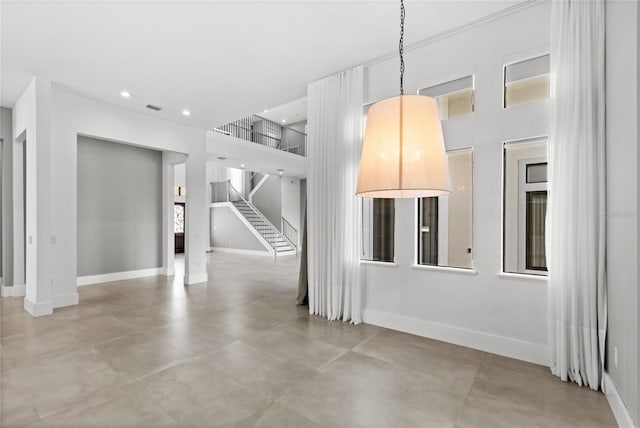 unfurnished living room with stairway, baseboards, visible vents, and recessed lighting