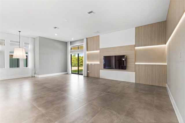 unfurnished living room featuring baseboards, recessed lighting, and visible vents