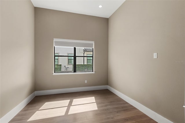 empty room with wood finished floors and baseboards