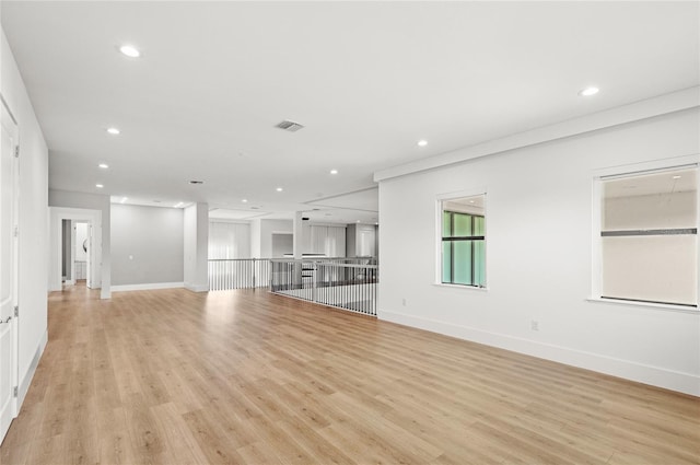unfurnished living room featuring light wood-style floors, visible vents, baseboards, and recessed lighting