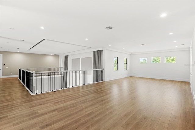 unfurnished room with light wood finished floors, baseboards, visible vents, and recessed lighting