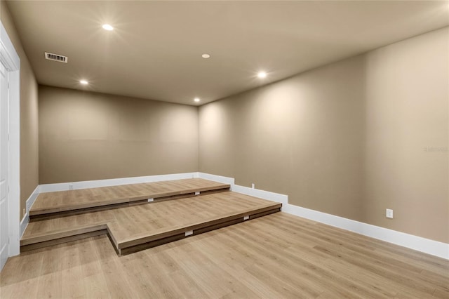 interior space with baseboards, recessed lighting, visible vents, and wood finished floors