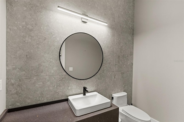 half bathroom with toilet and vanity