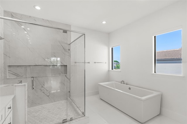 full bathroom with recessed lighting, a marble finish shower, and a freestanding tub