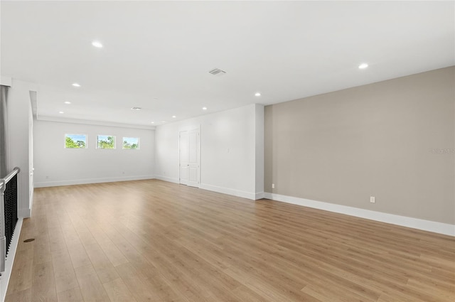 unfurnished living room with baseboards, light wood-style floors, and recessed lighting